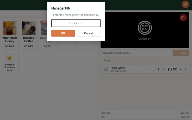 The till stopped before payment on a restricted item: a Manager PIN prompt reading Enter the manager PIN to check an ID, over a cart holding a bottle of hard cider