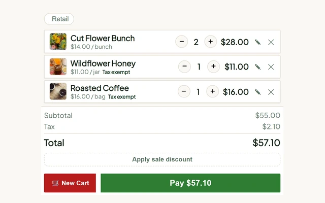 The till's cart with sales tax worked out: two bunches of cut flowers taxed, honey and coffee marked Tax exempt, and the subtotal of 55.00 dollars, tax of 2.10 dollars and total of 57.10 dollars beneath